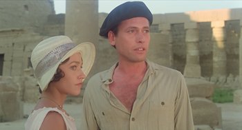 Movie still from “Death on the Nile” (1978), directed by John Guillermin – A man and a woman standing next to each other; Close Up shot, Low angle