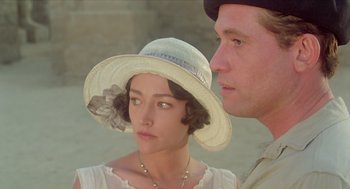 Movie still from “Death on the Nile” (1978), directed by John Guillermin – A man and a woman in a hat looking at each other; Close Up shot, Over the shoulder angle