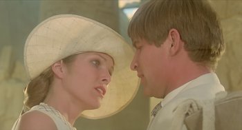 Movie still from “Death on the Nile” (1978), directed by John Guillermin – A man and a woman wearing a white hat; Close Up shot, Over the shoulder angle