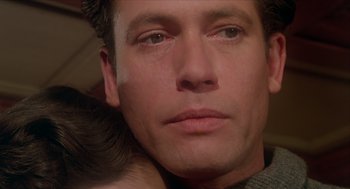 Movie still from “Death on the Nile” (1978), directed by John Guillermin – A man's face with his eyes closed; Close Up shot, Over the shoulder angle