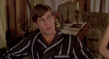 Movie still from “Death on the Nile” (1978), directed by John Guillermin – A young man in a black and white striped robe; Close Up shot, High angle