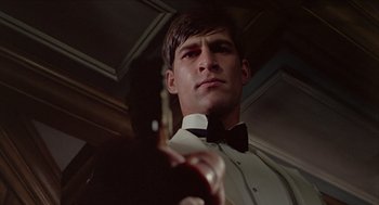 Movie still from “Death on the Nile” (1978), directed by John Guillermin – A person holding a guitar; Close Up shot, Low angle