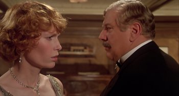 Movie still from “Death on the Nile” (1978), directed by John Guillermin – A man and a woman in formal wear looking at each other; Close Up shot, Over the shoulder angle