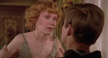 Movie still from “Death on the Nile” (1978), directed by John Guillermin – A woman in a dress and a man in a suit; Close Up shot, Over the shoulder angle