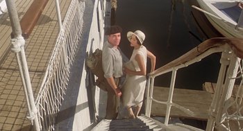 Movie still from “Death on the Nile” (1978), directed by John Guillermin – A man and a woman standing on the steps of a dock; Wide shot, Low angle