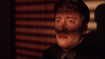 Movie still from “Death to Smoochy” (2002), directed by Danny DeVito – A person wearing a suit and tie; Close Up shot, Low angle