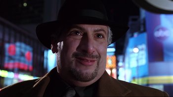 Movie still from “Death to Smoochy” (2002), directed by Danny DeVito – A person wearing a suit and hat; Close Up shot, Low angle