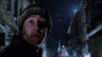 Movie still from “Death to Smoochy” (2002), directed by Danny DeVito – A person wearing a hat and looking at the camera; Close Up shot, Low angle