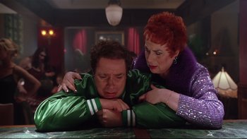 Movie still from “Death to Smoochy” (2002), directed by Danny DeVito – A man and a woman are sitting at a table; Medium shot, High angle