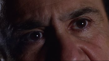 Movie still from “Death to Smoochy” (2002), directed by Danny DeVito – A man's eyes in the dark; Extreme Close Up shot, Low angle