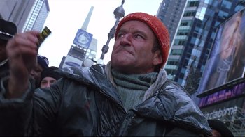 Movie still from “Death to Smoochy” (2002), directed by Danny DeVito – A man wearing a red hat and a black jacket; Close Up shot, Low angle