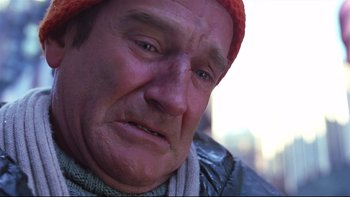 Movie still from “Death to Smoochy” (2002), directed by Danny DeVito – An older man wearing a red hat and a scarf; Close Up shot, Low angle