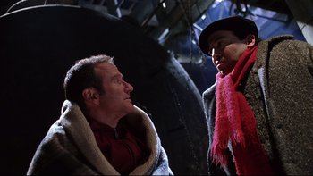 Movie still from “Death to Smoochy” (2002), directed by Danny DeVito – Two men talking to each other while wearing blankets; Close Up shot, Low angle