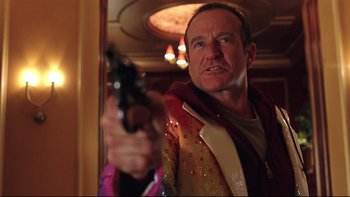 Movie still from “Death to Smoochy” (2002), directed by Danny DeVito – A man holding a gun in front of a mirror; Close Up shot, Low angle