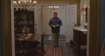 Movie still from “Deck the Halls” (2006), directed by John Whitesell – A man walking through a doorway to a dinning room; Wide shot, High angle