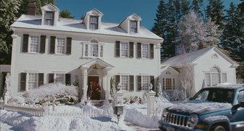 Movie still from “Deck the Halls” (2006), directed by John Whitesell – A large white house with a car parked in front of it; Extreme Wide shot, Low angle