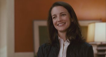 Movie still from “Deck the Halls” (2006), directed by John Whitesell – A woman smiling for the camera in a black jacket; Close Up shot, Over the shoulder angle