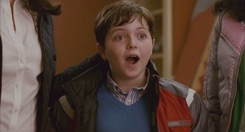 Movie still from “Deck the Halls” (2006), directed by John Whitesell – A young boy with a surprised look on his face; Close Up shot, Over the shoulder angle