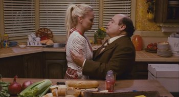 Movie still from “Deck the Halls” (2006), directed by John Whitesell – A man and a woman in a kitchen with sandwiches on the table; Medium shot, Over the shoulder angle