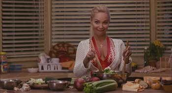 Movie still from “Deck the Halls” (2006), directed by John Whitesell – A woman sitting at a table with a bowl of food; Medium shot, Over the shoulder angle