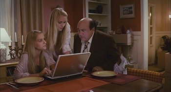Movie still from “Deck the Halls” (2006), directed by John Whitesell – A man and two women looking at a laptop; Medium shot, High angle