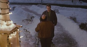 Movie still from “Deck the Halls” (2006), directed by John Whitesell – Two men standing on the side of a road talking to each other; Medium shot, Over the shoulder angle