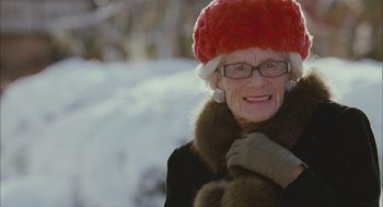 Movie still from “Deck the Halls” (2006), directed by John Whitesell – An older woman wearing a red hat and gloves; Close Up shot, Low angle