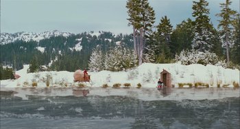 Movie still from “Deck the Halls” (2006), directed by John Whitesell – A man riding a horse drawn carriage across a river; Extreme Wide shot, High angle