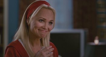 Movie still from “Deck the Halls” (2006), directed by John Whitesell – A woman in a red shirt holding a glass of water; Close Up shot, Over the shoulder angle