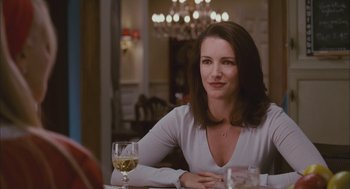 Movie still from “Deck the Halls” (2006), directed by John Whitesell – A woman sitting at a table with a glass of wine; Close Up shot, Over the shoulder angle