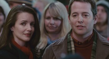 Movie still from “Deck the Halls” (2006), directed by John Whitesell – A man and a woman standing next to each other in front of another man; Close Up shot, Over the shoulder angle