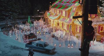 Movie still from “Deck the Halls” (2006), directed by John Whitesell – A truck is parked in front of a house decorated for the holidays; Extreme Wide shot, High angle