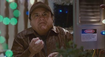 Movie still from “Deck the Halls” (2006), directed by John Whitesell – A man in a brown jacket eating a donut; Close Up shot, Low angle
