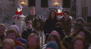 Movie still from “Deck the Halls” (2006), directed by John Whitesell – A group of people standing in front of a picket fence; Medium shot, Over the shoulder angle