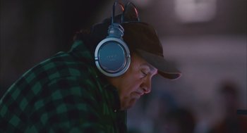 Movie still from “Deck the Halls” (2006), directed by John Whitesell – A man with a hat and headphones is listening to music; Close Up shot, Low angle