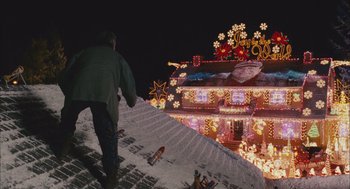 Movie still from “Deck the Halls” (2006), directed by John Whitesell – A man walking up the stairs to a house decorated with christmas lights; Extreme Wide shot, Low angle