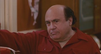 Movie still from “Deck the Halls” (2006), directed by John Whitesell – A man with a bald head wearing a red shirt; Close Up shot, High angle
