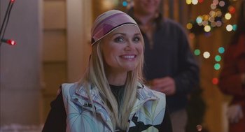 Movie still from “Deck the Halls” (2006), directed by John Whitesell – A woman wearing a hat smiling for the camera; Close Up shot, Over the shoulder angle