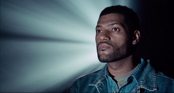Movie still from “Deep Cover” (1992), directed by Bill Duke – A person looking up at the sky; Close Up shot, Low angle