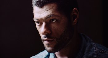 Movie still from “Deep Cover” (1992), directed by Bill Duke – A person with a beard; Close Up shot, Low angle