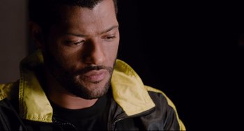 Movie still from “Deep Cover” (1992), directed by Bill Duke – A person wearing a black and yellow jacket; Close Up shot, High angle