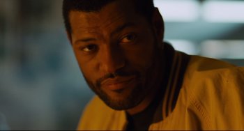 Movie still from “Deep Cover” (1992), directed by Bill Duke – A man's face in the dark; Close Up shot, Over the shoulder angle