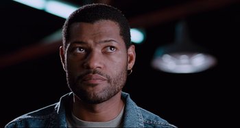 Movie still from “Deep Cover” (1992), directed by Bill Duke – A person wearing a jean jacket; Close Up shot, Low angle