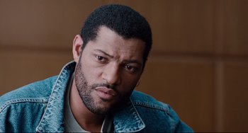 Movie still from “Deep Cover” (1992), directed by Bill Duke – A person wearing a jean jacket; Close Up shot, High angle