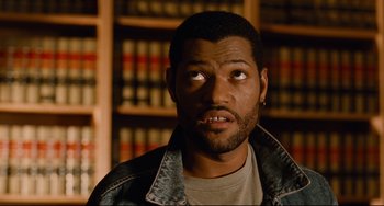 Movie still from “Deep Cover” (1992), directed by Bill Duke – A person wearing a jean jacket; Close Up shot, High angle