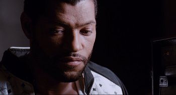 Movie still from “Deep Cover” (1992), directed by Bill Duke – A person wearing a shirt; Close Up shot, High angle