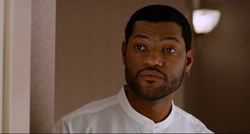 Movie still from “Deep Cover” (1992), directed by Bill Duke – A person wearing a white shirt; Close Up shot, Over the shoulder angle