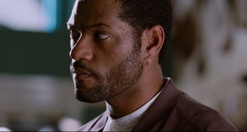 Movie still from “Deep Cover” (1992), directed by Bill Duke – A person with a beard; Close Up shot, Low angle
