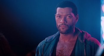 Movie still from “Deep Cover” (1992), directed by Bill Duke – A person wearing a jacket; Close Up shot, Over the shoulder angle