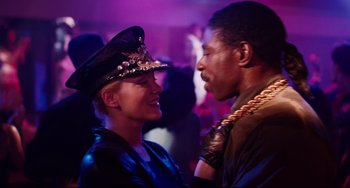 Movie still from “Deep Cover” (1992), directed by Bill Duke – A man and a woman are dressed in military attire; Close Up shot, Over the shoulder angle